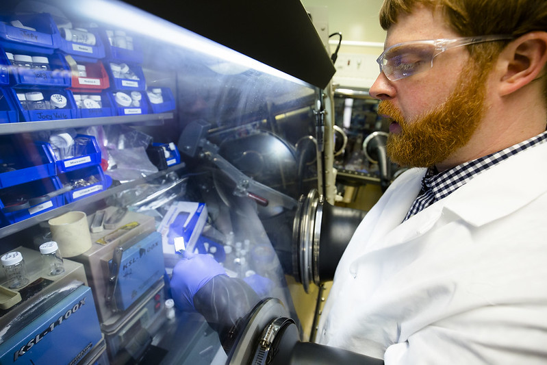 Nathan Taylor, a post-doctoral fellow in mechanical engineering, inspects a piece of lithium metal